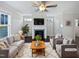 Virtually staged living room with fireplace and neutral colored furniture at 917 Palm Ct, Mebane, NC 27302