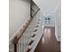 Staircase with wooden railing leading to the second floor at 917 Palm Ct, Mebane, NC 27302