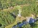 Aerial shot of a wooded property with a home nestled among the trees at 105 N Bend Dr, Knightdale, NC 27545