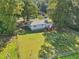 Aerial view of a property showcasing a spacious backyard with mature trees and fencing at 105 N Bend Dr, Knightdale, NC 27545