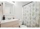 Clean bathroom with updated vanity, shower, and decorative shower curtain at 105 N Bend Dr, Knightdale, NC 27545