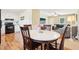 Bright dining area features an oval table with four chairs, adjacent to a kitchen and living room at 105 N Bend Dr, Knightdale, NC 27545