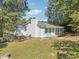 Exterior elevation of a charming home with gray siding, brick foundation, and blue trim at 105 N Bend Dr, Knightdale, NC 27545
