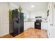 Modern kitchen featuring white cabinets, black appliances, and granite countertops at 105 N Bend Dr, Knightdale, NC 27545
