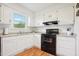 Efficient kitchen with white cabinets and black appliances at 105 N Bend Dr, Knightdale, NC 27545
