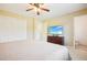 Main bedroom with king-size bed, built-in shelving, and private bathroom access at 105 N Bend Dr, Knightdale, NC 27545