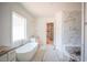 Bright bathroom features soaking tub, marble shower and access to custom closet at 1116 Delilia Ln, Wake Forest, NC 27587