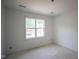 Unfinished bedroom has a large window letting in natural light at 1116 Delilia Ln, Wake Forest, NC 27587