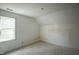 Unfinished bedroom boasts an attic window and ample space at 1116 Delilia Ln, Wake Forest, NC 27587