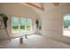 A bedroom being painted, featuring a row of windows offering natural light and views of the surrounding landscape at 1116 Delilia Ln, Wake Forest, NC 27587
