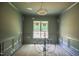 Formal dining room with decorative chandelier and classic wainscoting at 1116 Delilia Ln, Wake Forest, NC 27587
