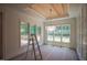 Dining area with a wood-paneled ceiling, modern chandelier, and large windows at 1116 Delilia Ln, Wake Forest, NC 27587