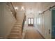 Bright hallway with staircase, chandelier, wainscoting, and double-door entrance at 1116 Delilia Ln, Wake Forest, NC 27587