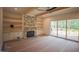 Cozy living room with a stone fireplace, built-in shelves, and a sliding glass door to deck at 1116 Delilia Ln, Wake Forest, NC 27587