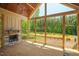 Screened-in porch with a stone fireplace and a wooded view at 1116 Delilia Ln, Wake Forest, NC 27587