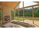 Covered porch with fireplace and views of the outdoor nature setting at 1116 Delilia Ln, Wake Forest, NC 27587