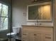 Clean bathroom with white vanity and large mirror at 1312 Fay St, Durham, NC 27701