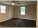 Simple bedroom with hardwood floors and ceiling fan at 1312 Fay St, Durham, NC 27701