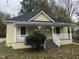 Charming yellow home with a welcoming front porch and well-maintained landscaping at 1312 Fay St, Durham, NC 27701