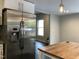 Kitchen with stainless steel refrigerator and butcher block island at 1312 Fay St, Durham, NC 27701