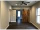 Spacious living room featuring dark floors and a rustic barn door detail at 1312 Fay St, Durham, NC 27701