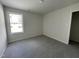 Bright bedroom with new carpet and a window at 16 Holly Grove Ln, Lillington, NC 27546