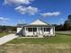 Newly built home with front porch and landscaped lawn at 16 Holly Grove Ln, Lillington, NC 27546