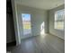 Room with door leading to deck and wooded view at 16 Holly Grove Ln, Lillington, NC 27546