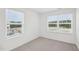 Bright bedroom with two large windows and grey carpet at 2052 Glen Crossing Dr, Durham, NC 27704