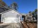 Gray sided house with white garage door and brick accents at 2106 Pathway Dr, Chapel Hill, NC 27516