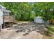Spacious backyard with a detached garage and wooden deck, perfect for outdoor activities and entertaining at 2612 Ashe St, Durham, NC 27703
