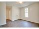 Bedroom featuring hardwood floors, a closet, and a bright window at 2612 Ashe St, Durham, NC 27703
