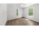 Neutral bedroom with hardwood floors and large windows providing ample natural light at 2612 Ashe St, Durham, NC 27703