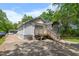 Rear exterior view of the house featuring a wooden deck and access to the backyard at 2612 Ashe St, Durham, NC 27703
