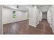 Hallway with hardwood floors and white walls, offering a bright and spacious feel at 2612 Ashe St, Durham, NC 27703