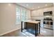 Modern kitchen showcases a kitchen island, stainless steel appliances, and bright natural light at 2612 Ashe St, Durham, NC 27703