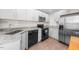 Modern kitchen with stainless steel appliances, granite countertops, and white cabinetry at 2612 Ashe St, Durham, NC 27703