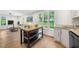 Open-concept living room with a large window and a kitchen island with granite countertops at 2612 Ashe St, Durham, NC 27703