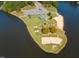 Aerial view of a waterfront property with a sandy beach, mini-golf, and park at 2662 Sledge Rd, Louisburg, NC 27549