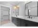 Bathroom featuring double sinks with modern fixtures, vanity with marble countertop, and stylish lighting at 2662 Sledge Rd, Louisburg, NC 27549