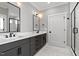 Bathroom featuring double sinks with modern fixtures, vanity with marble countertop, and stylish lighting at 2662 Sledge Rd, Louisburg, NC 27549