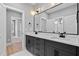 Modern bathroom featuring double sink vanity, stylish mirrors, and elegant fixtures at 2662 Sledge Rd, Louisburg, NC 27549