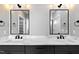 Bathroom featuring double sinks with modern fixtures, vanity with marble countertop, and stylish lighting at 2662 Sledge Rd, Louisburg, NC 27549