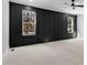 Bedroom with modern black accent wall, carpeted flooring, and natural light from two large windows at 2662 Sledge Rd, Louisburg, NC 27549