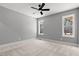 Spacious bedroom with a ceiling fan and large bright windows at 2662 Sledge Rd, Louisburg, NC 27549