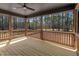 Wide view of the wooden deck with a ceiling fan, providing beautiful views of the wooded backyard at 2662 Sledge Rd, Louisburg, NC 27549