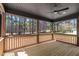 Spacious wooden deck with ceiling fan and views of the trees and landscaping at 2662 Sledge Rd, Louisburg, NC 27549