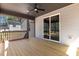 Spacious covered deck with ceiling fan and view of the backyard through sliding glass doors at 2662 Sledge Rd, Louisburg, NC 27549