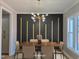 Dining room with modern chandelier and wood accent wall staged with table and chairs at 2662 Sledge Rd, Louisburg, NC 27549