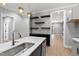 Stylish kitchen features gray cabinets, quartz countertops, stainless appliances and custom shelving at 2662 Sledge Rd, Louisburg, NC 27549